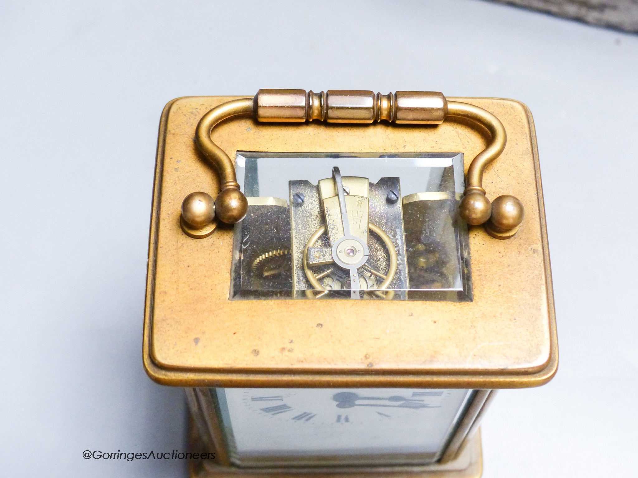A cased carriage clock and a silver mounted motorwatch